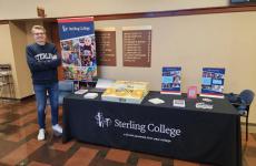 person standing next to a display table