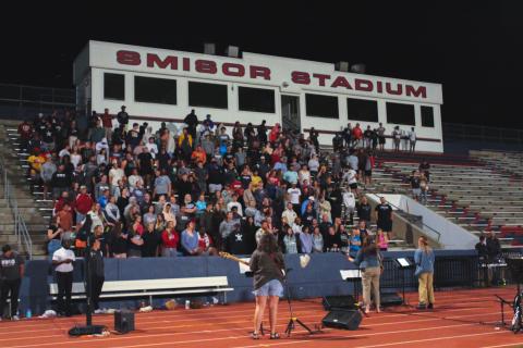 Football stadium of people singing 