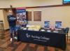 person standing next to a display table